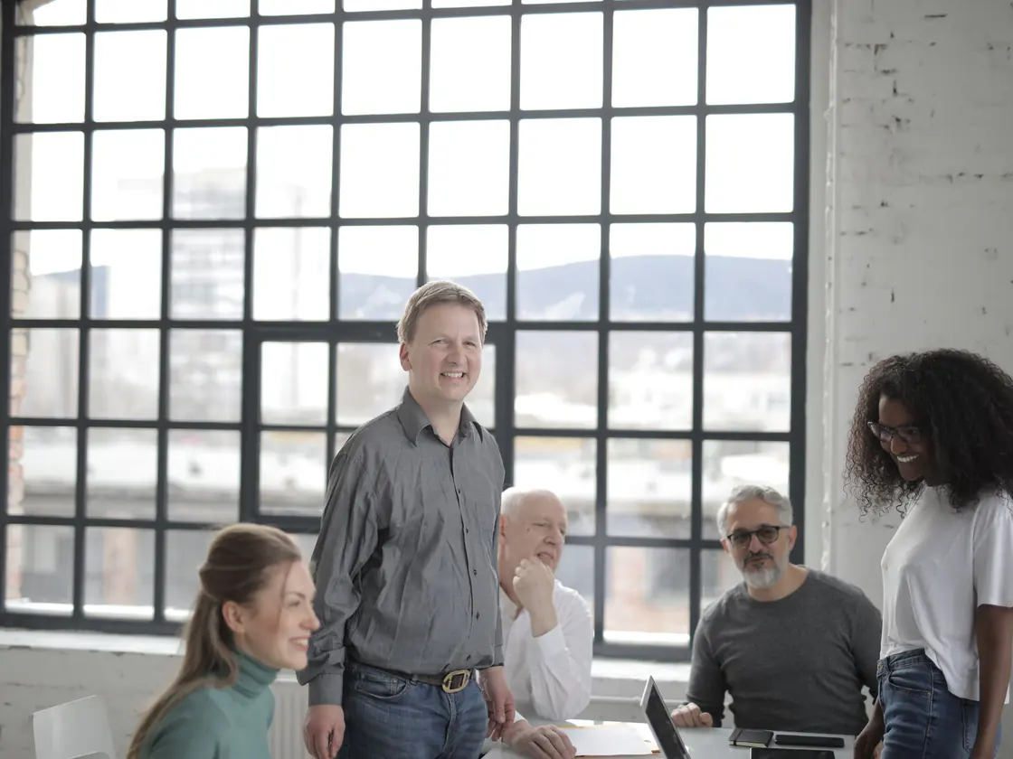 A team of employees covered by a group benefit plan meeting in their office
