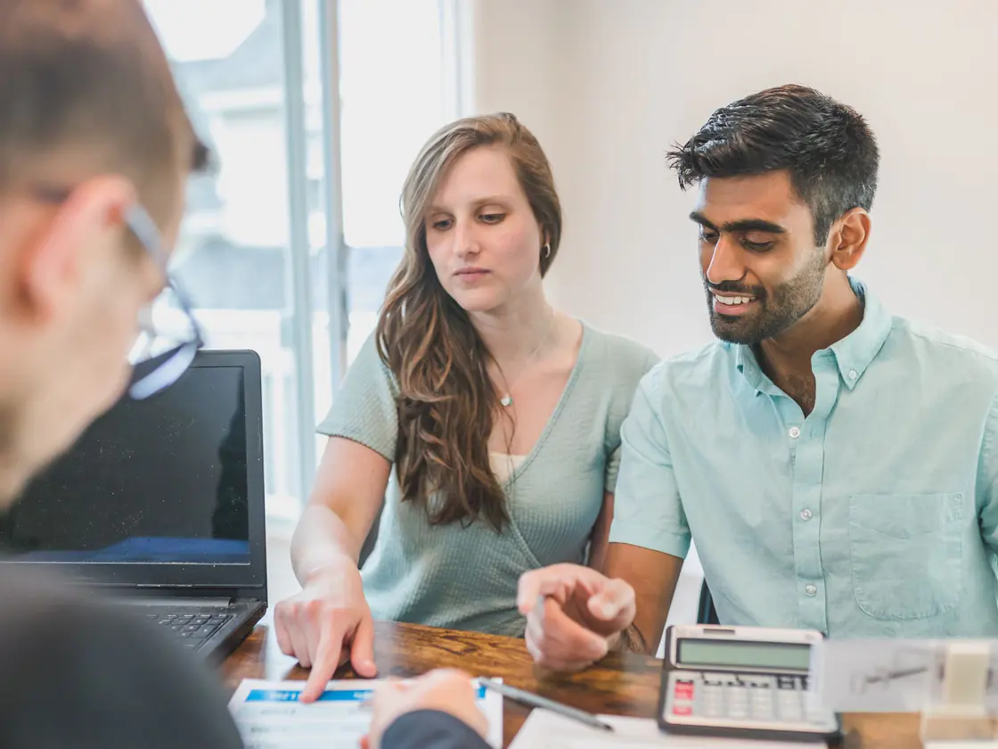 A PolyLine Group advisor reviewing a household budget with a couple