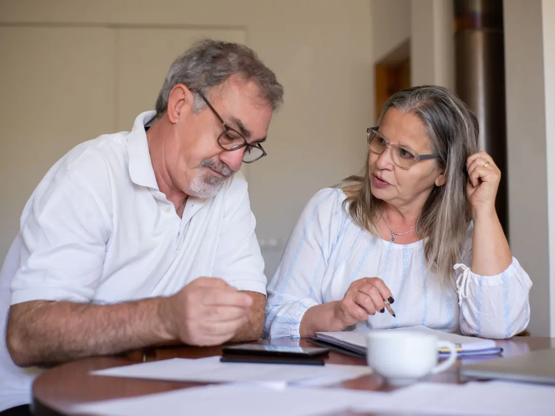 A couple reviewing their RRSP contribution paperwork together