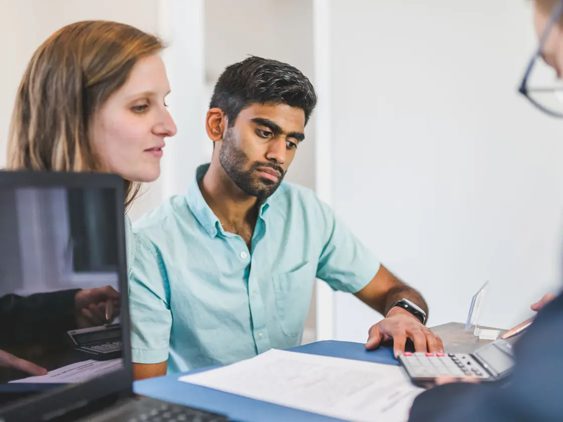 A couple reviewing residential mortgage options with their broker